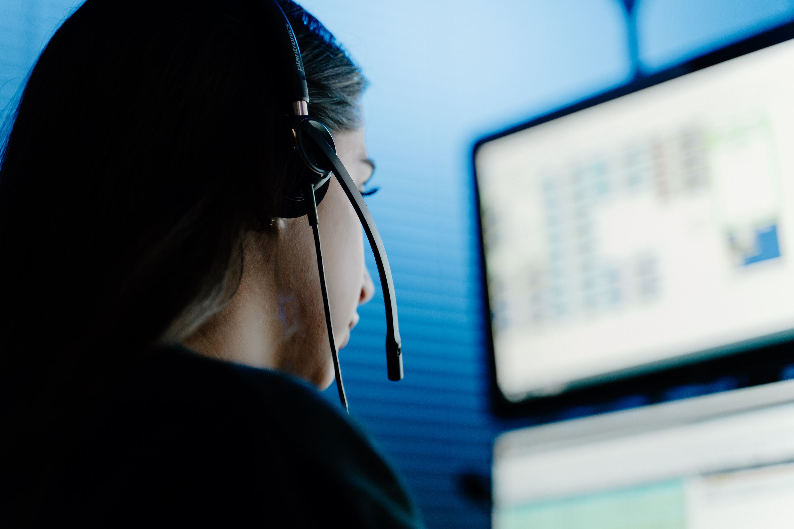 A police dispatcher working at a computer terminal.